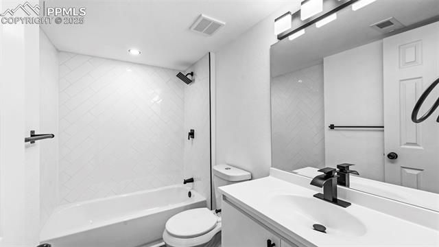 562 Blossom Field Road Fountain, CO 80817 - Photo 23 of 41 Full bath with tile shower / bathtub combination, vanity, and a textured wall