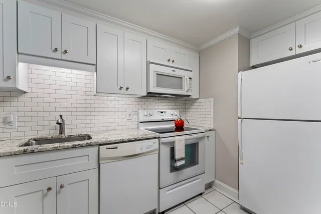 a kitchen with stainless steel appliances granite countertop white refrigerator stove a sink and dishwasher