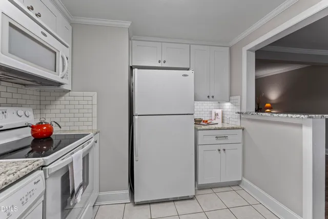 a kitchen with stainless steel appliances a stove microwave and refrigerator
