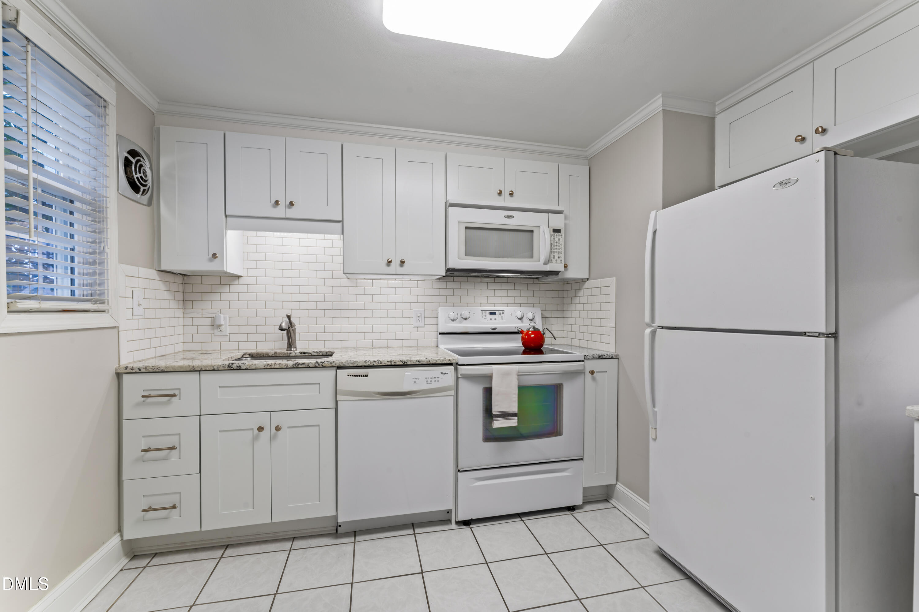 715 Wade Avenue Raleigh, NC 27605 - Photo 15 of 41 a kitchen with white cabinets and white appliances