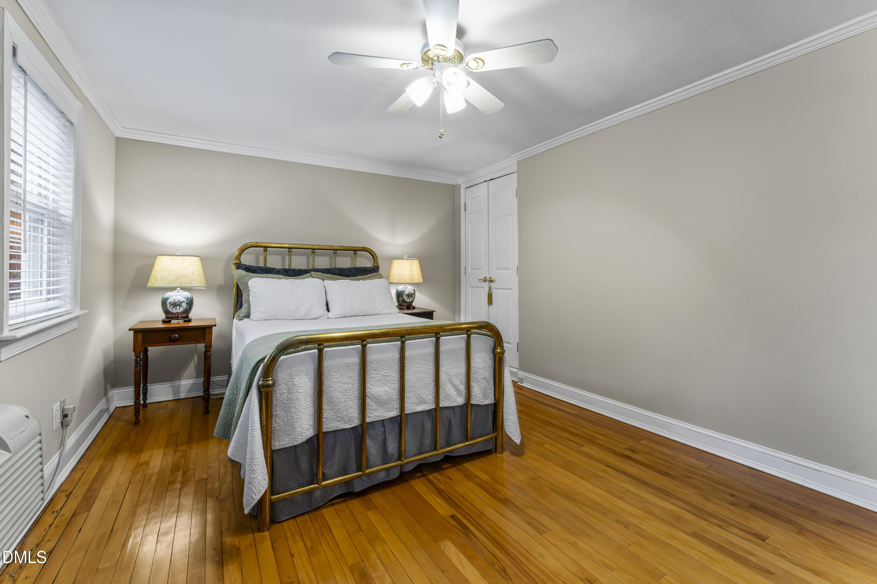 715 Wade Avenue Raleigh, NC 27605 - Photo 22 of 41 a bedroom with a bed and wooden floor