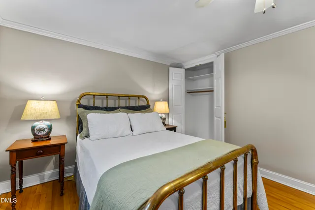 a bedroom with a bed and a lamp on table