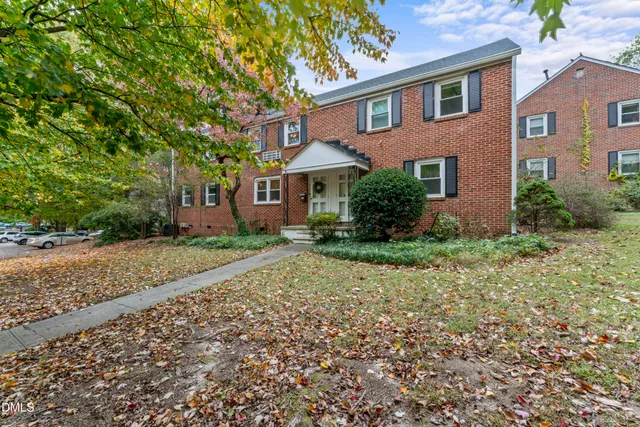 an aerial view of a house with a yard and lake view