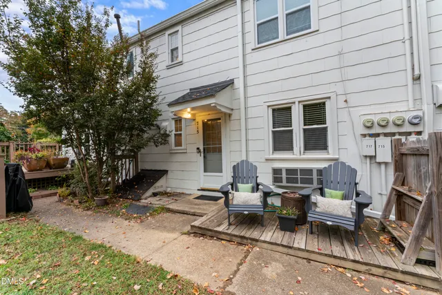 an aerial view of a house with outdoor space and a lake view in back