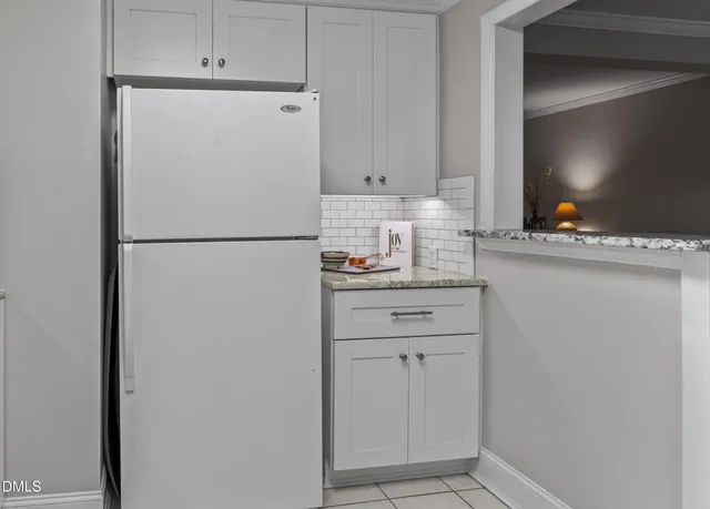 a white refrigerator freezer sitting in a kitchen