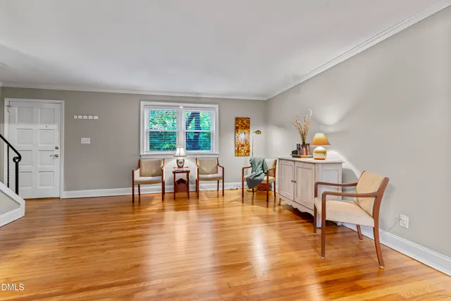 a view of a dining room with furniture and wooden floor windows