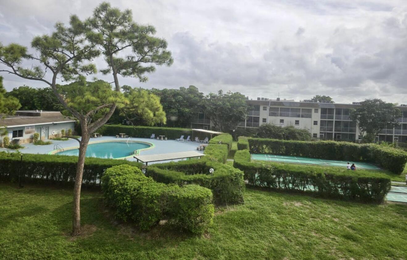 2100 Springdale Boulevard, Unit 306 Palm Springs, FL 33461 - Photo 2 of 19 an aerial view of a house having swimming pool having outdoor seating