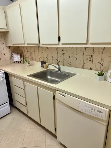 a stove top oven sitting inside of a kitchen