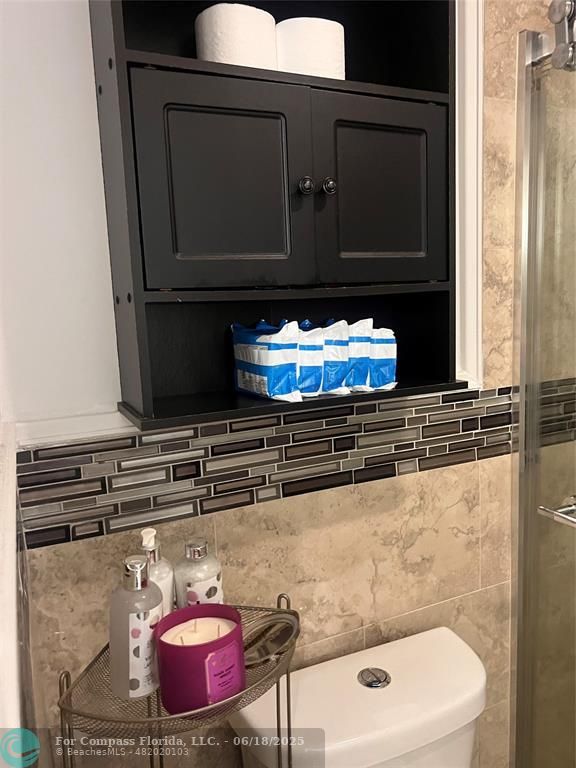 3461 Cocoplum Circle, Unit 3431 Coconut Creek, FL 33063 - Photo 12 of 16 a bathroom with a stove and a microwave