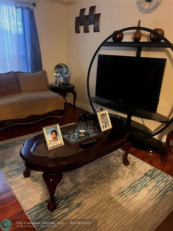 3461 Cocoplum Circle, Unit 3431 Coconut Creek, FL 33063 - Photo 14 of 16 a living room with furniture and a mirror