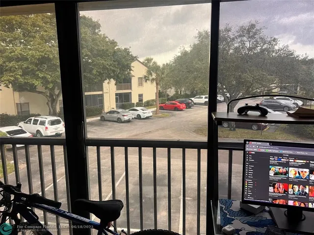 a view of a balcony with chairs and table