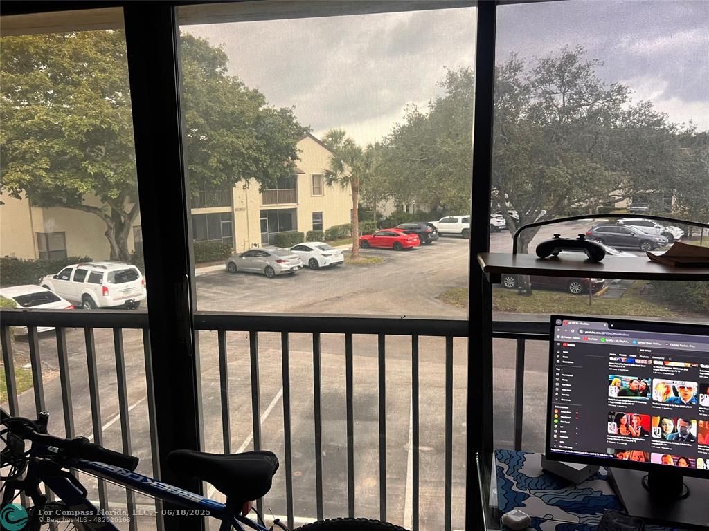 3461 Cocoplum Circle, Unit 3431 Coconut Creek, FL 33063 - Photo 16 of 16 a view of a balcony with chairs and table