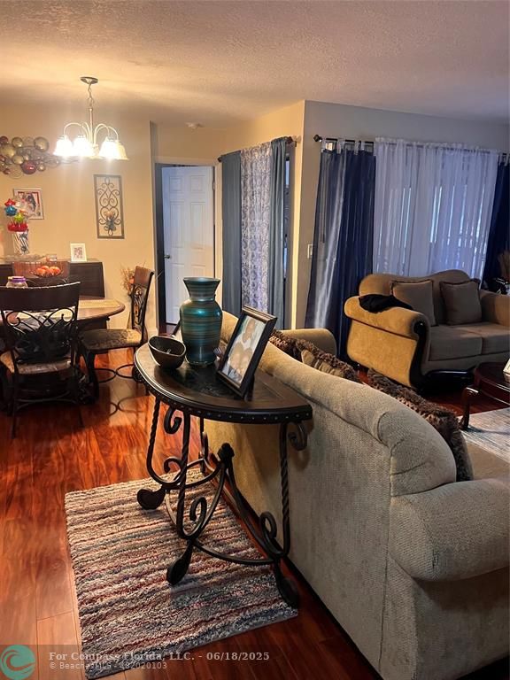 3461 Cocoplum Circle, Unit 3431 Coconut Creek, FL 33063 - Photo 2 of 16 a bedroom with furniture and a wooden floor