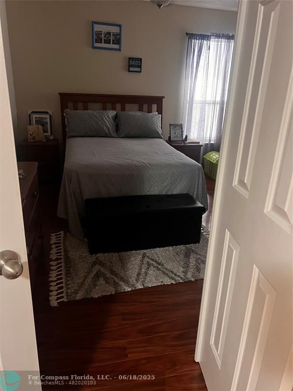 3461 Cocoplum Circle, Unit 3431 Coconut Creek, FL 33063 - Photo 6 of 16 a bed sitting in a bedroom next to a window