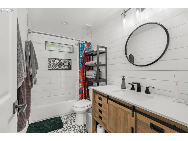 a bathroom with a sink a toilet and a mirror