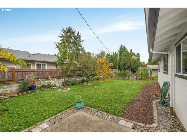 a backyard of a house with a garden and plants