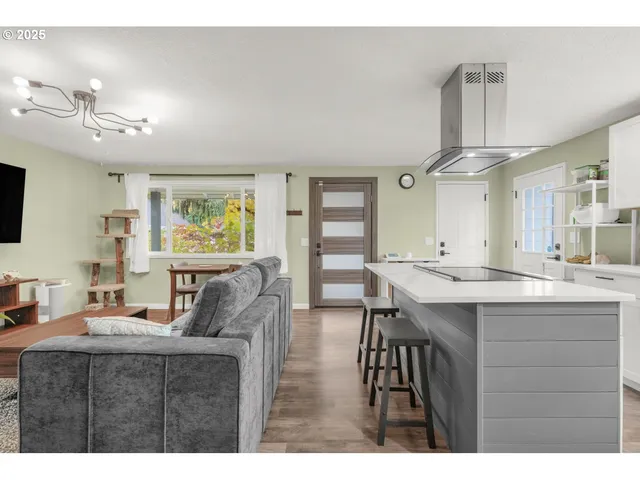 a living room with furniture a desk and chair