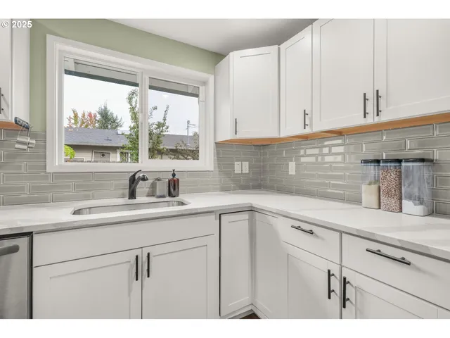 a kitchen with appliances cabinets and a window