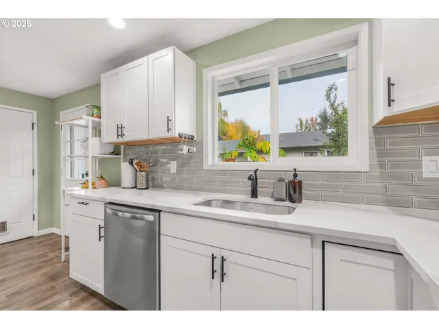 a kitchen with a sink cabinets and window