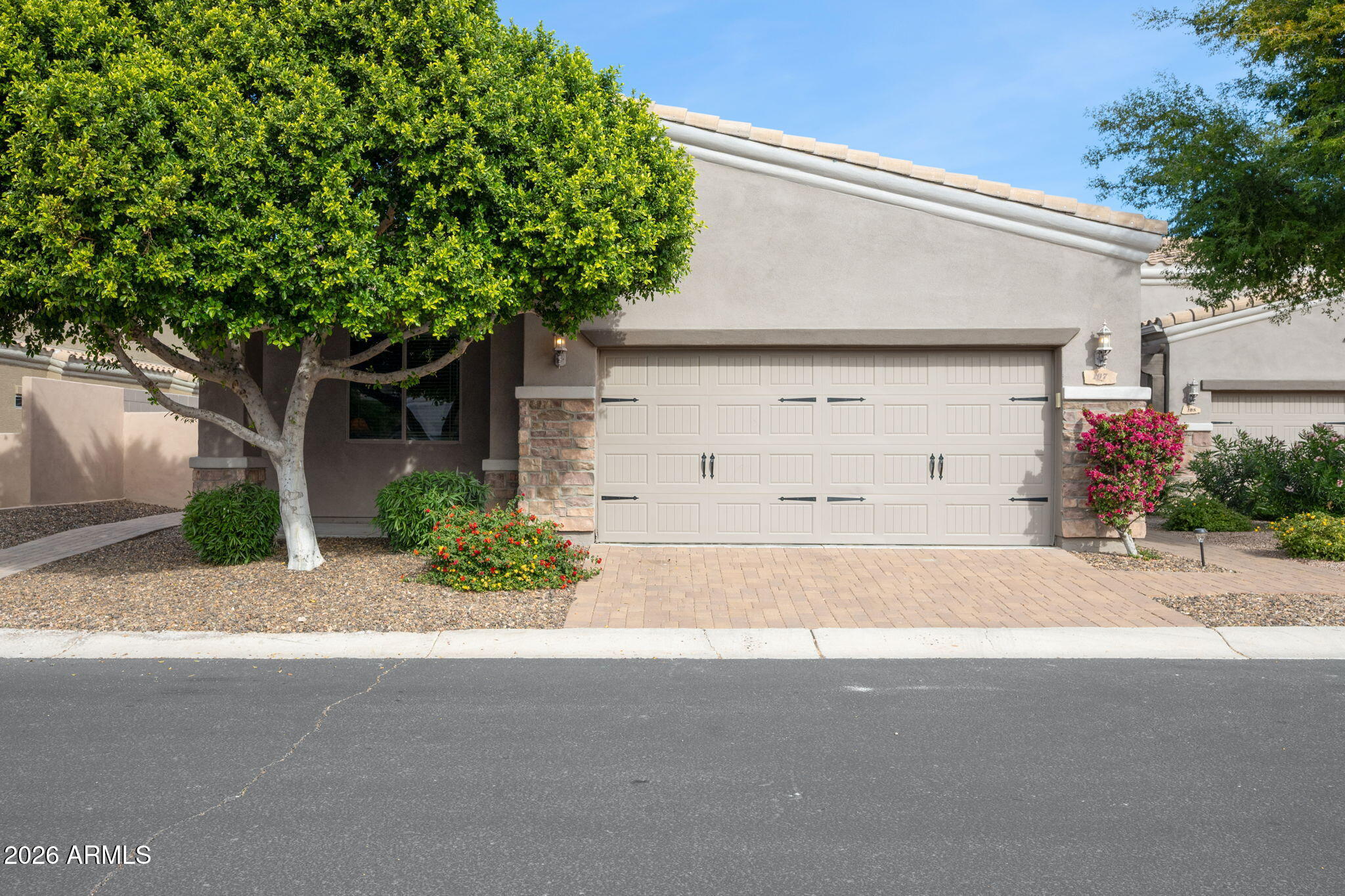 a front view of a house with a yard and a garage