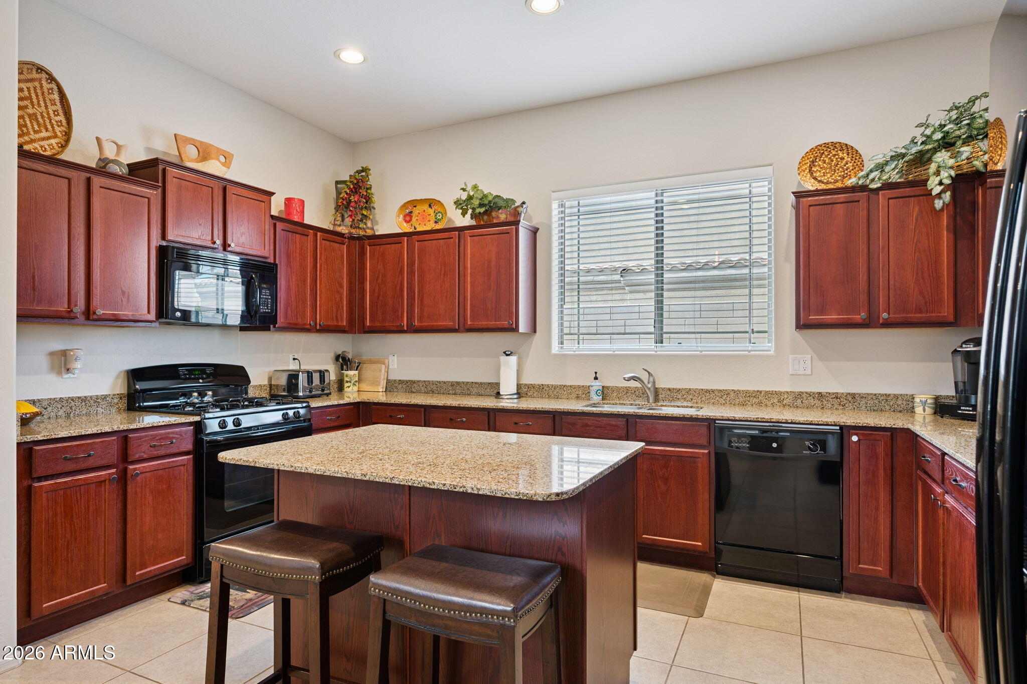 6202 East McKellips Road, Unit 107 Mesa, AZ 85215 - Photo 13 of 32 a kitchen with stainless steel appliances granite countertop a sink a stove a refrigerator cabinets and a window