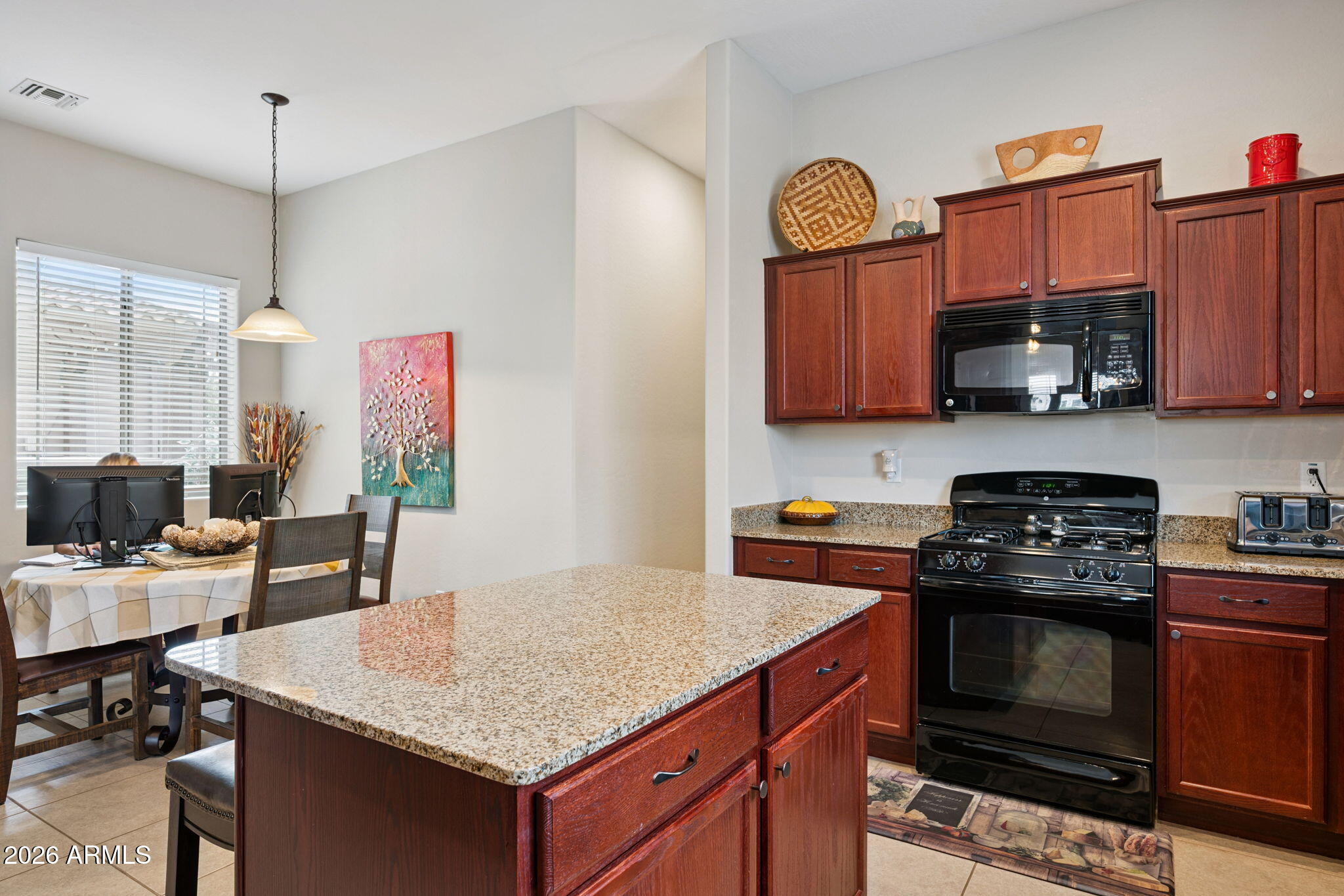 6202 East McKellips Road, Unit 107 Mesa, AZ 85215 - Photo 14 of 32 a kitchen with stainless steel appliances granite countertop a stove a sink and a microwave