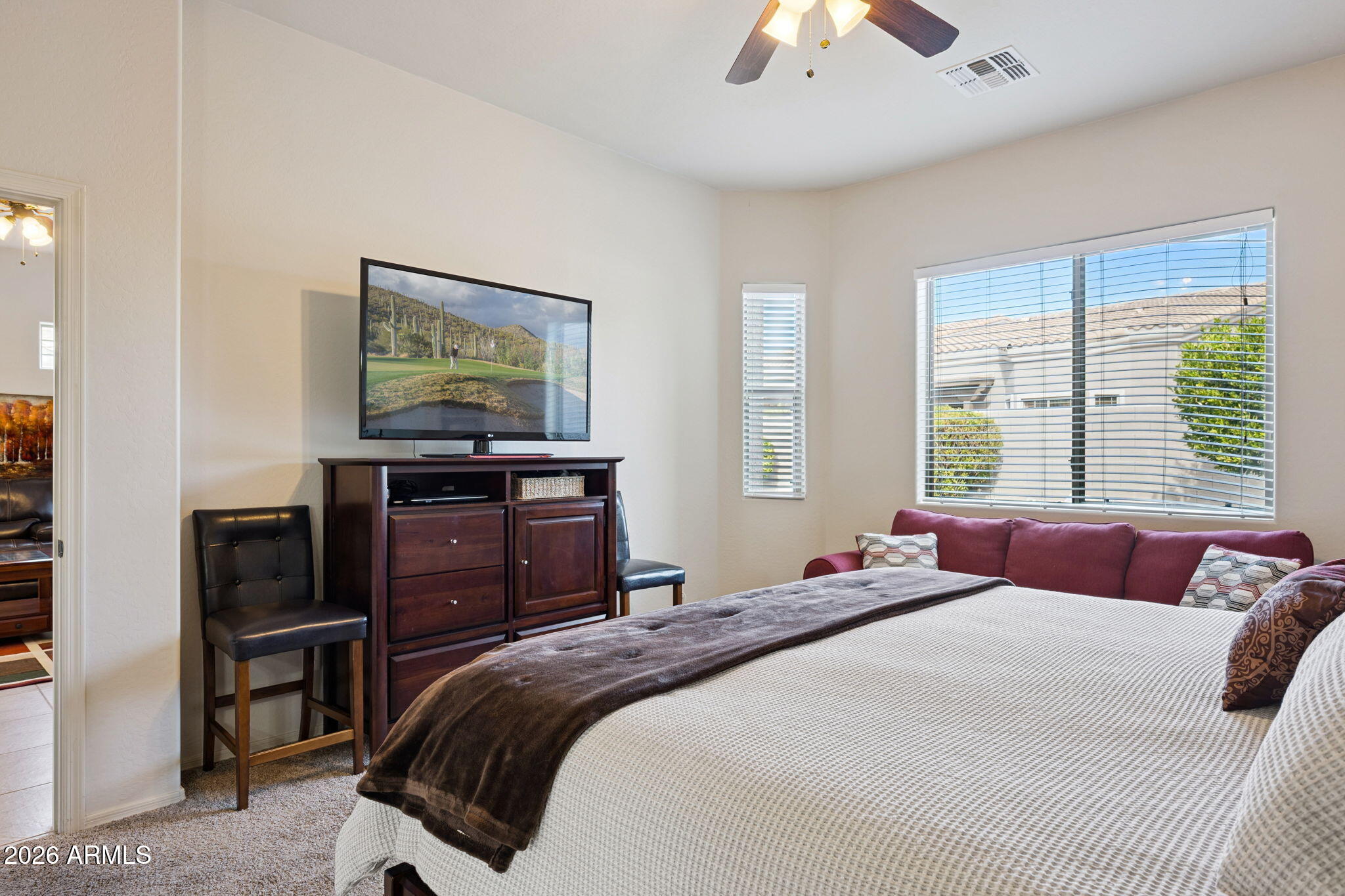6202 East McKellips Road, Unit 107 Mesa, AZ 85215 - Photo 17 of 32 a bedroom with a bed and a chandelier