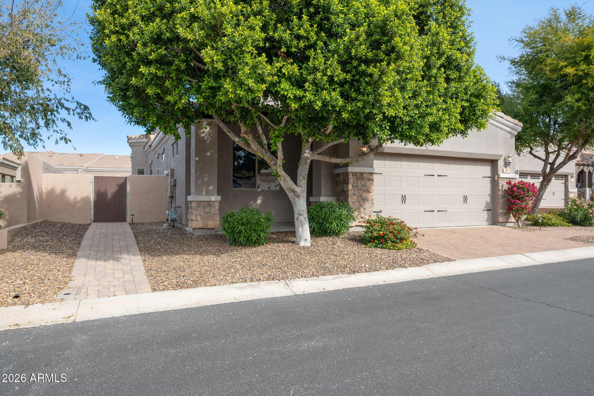 6202 East McKellips Road, Unit 107 Mesa, AZ 85215 - Photo 2 of 32 a white house that has a tree in front of it