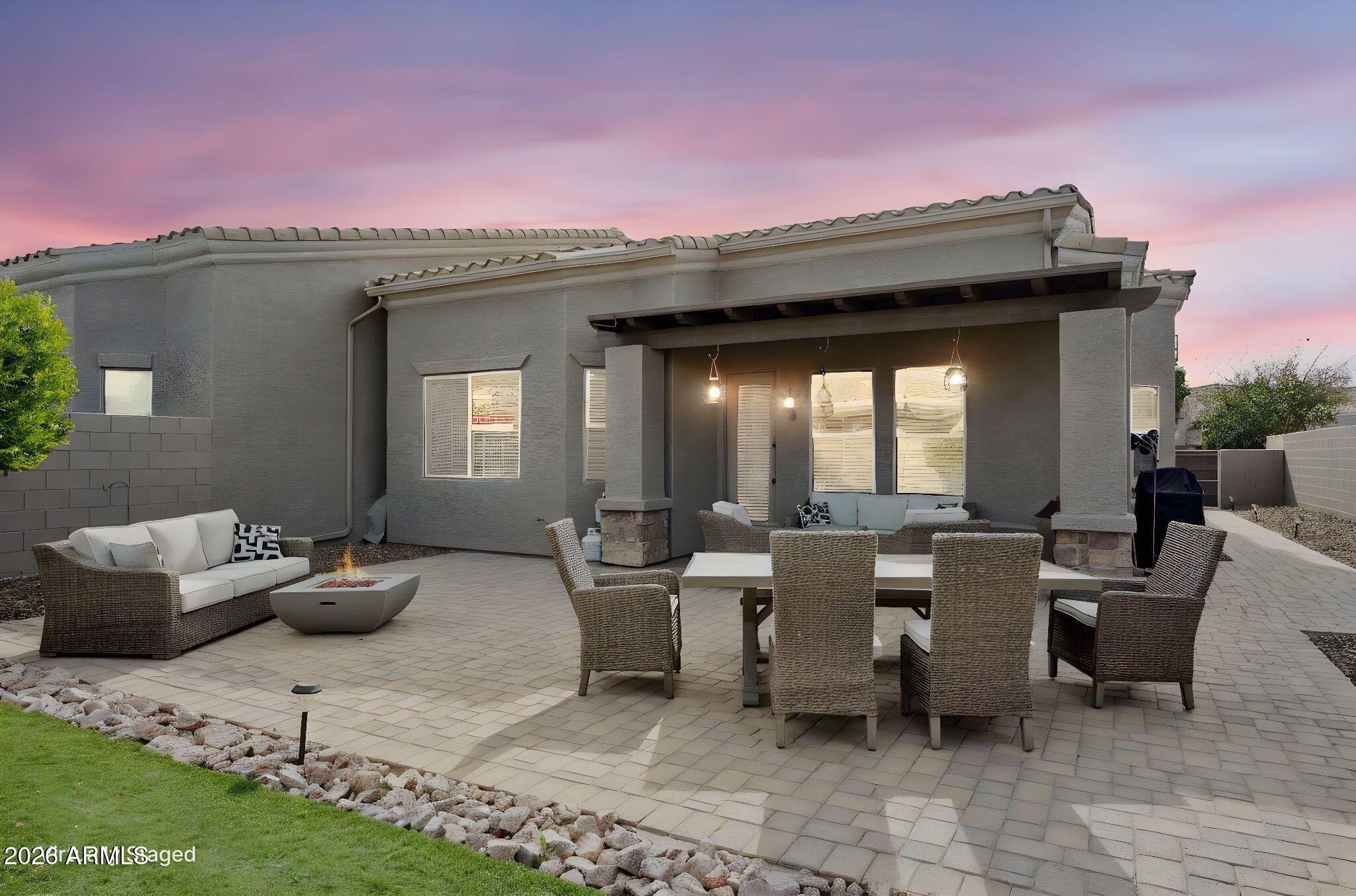 6202 East McKellips Road, Unit 107 Mesa, AZ 85215 - Photo 30 of 32 a view of a patio with couches table and chairs and potted plants