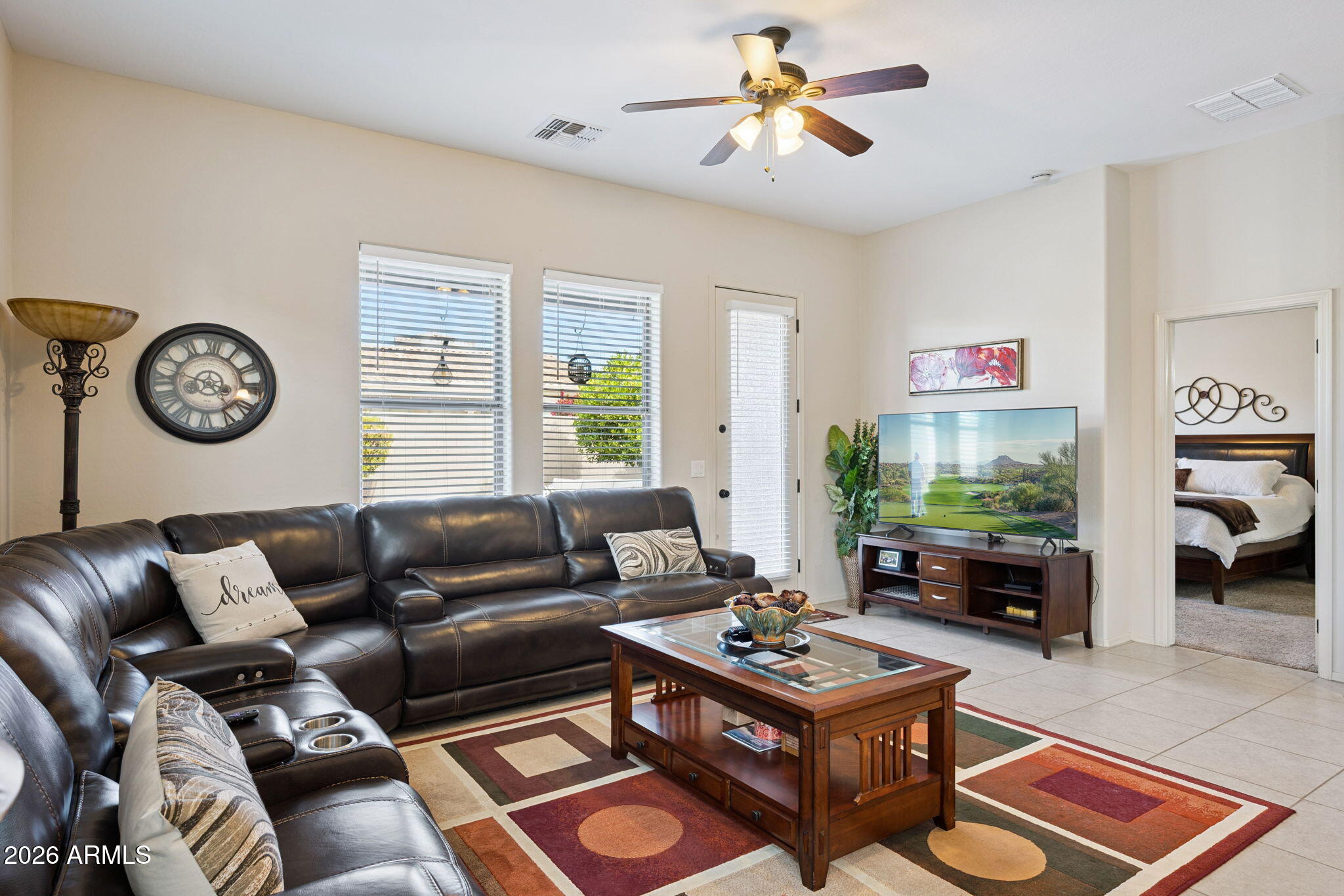 6202 East McKellips Road, Unit 107 Mesa, AZ 85215 - Photo 7 of 32 a living room with furniture a rug and a window