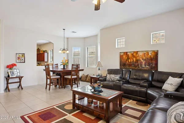 a living room with furniture a dining table and a piano table