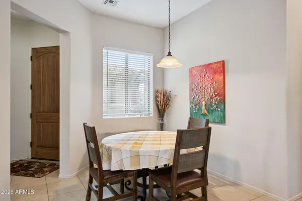 a view of a dining room with furniture and a window