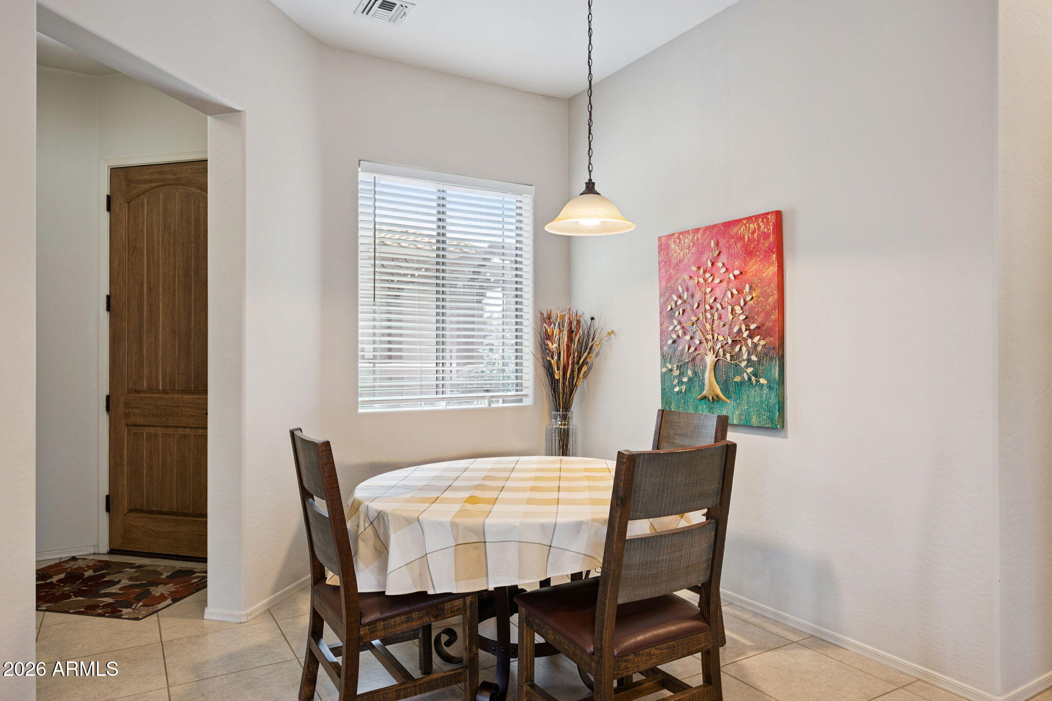 6202 East McKellips Road, Unit 107 Mesa, AZ 85215 - Photo 9 of 32 a view of a dining room with furniture and a window