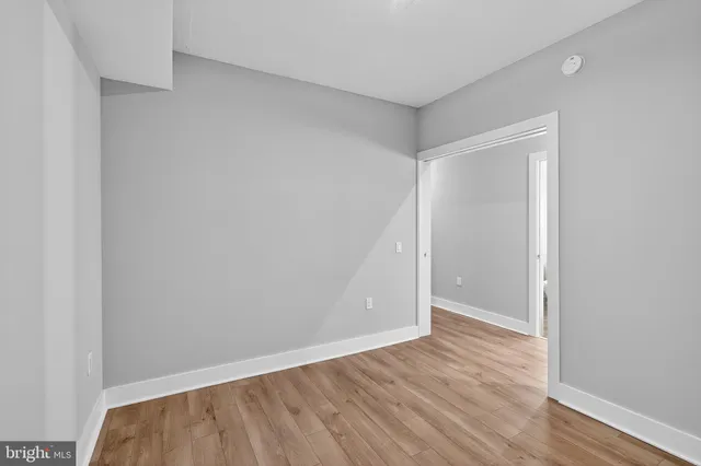 a view of walk in closet with empty racks