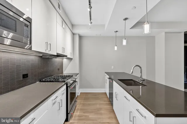 a kitchen that has a sink and a stove