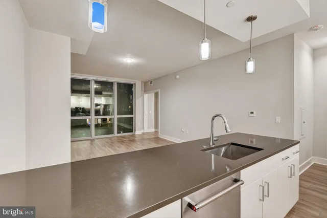 a kitchen with a sink and chandelier