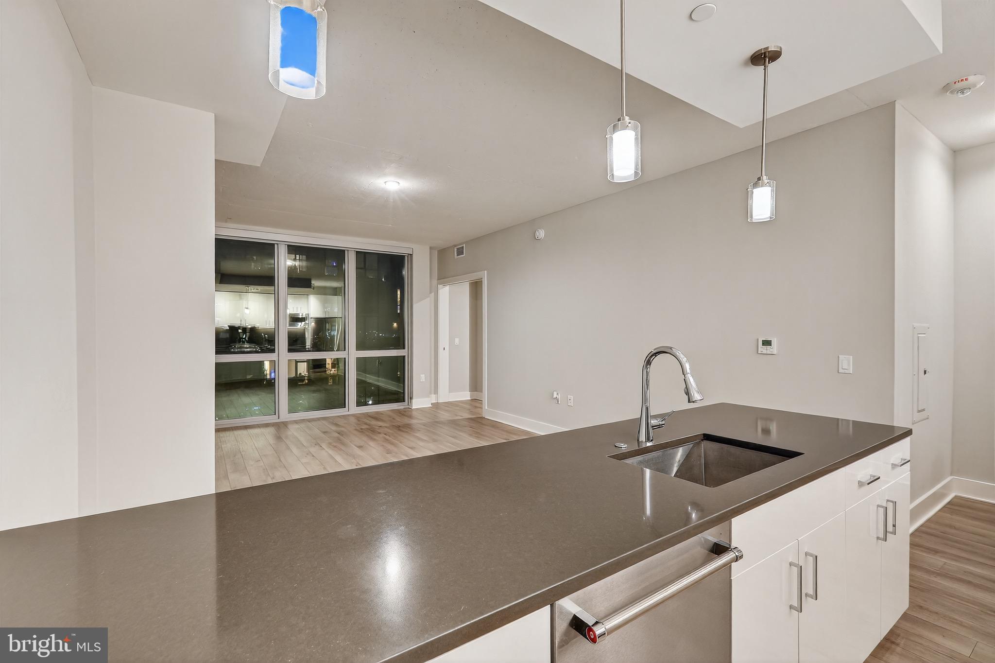 88 V Street Southwest, Unit 509 Washington, DC 20024 - Photo 8 of 36 a kitchen with a sink and chandelier