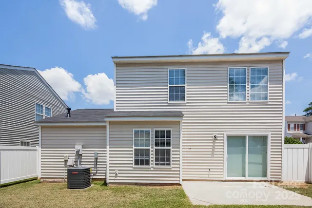 a view of a house with more windows and potted plants