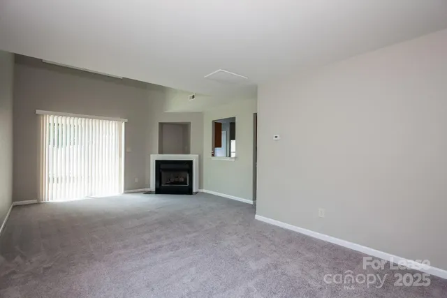 a view of empty room with a fireplace