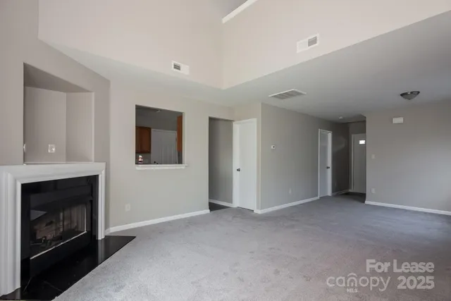 a view of an empty room with a fireplace
