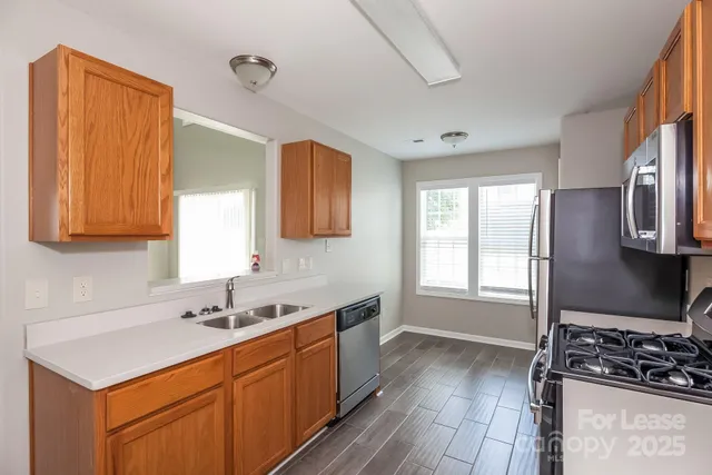 a kitchen that has a sink and a stove in it