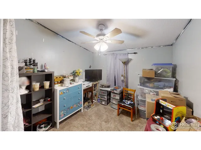 a workspace with furniture and a fan