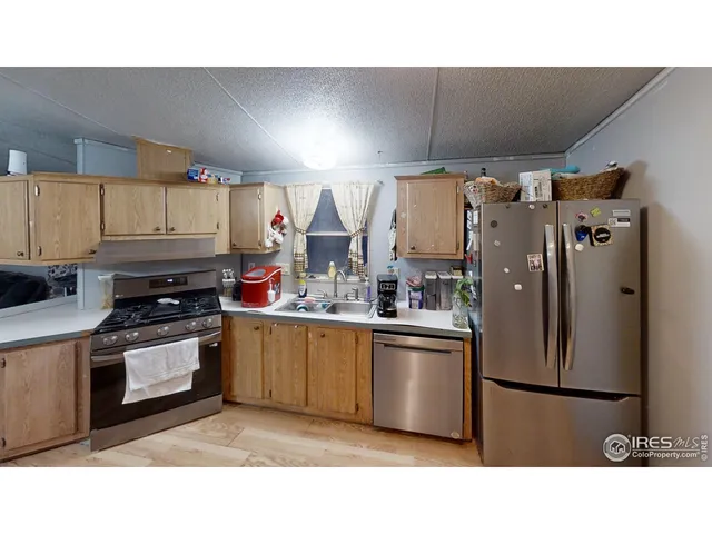 a kitchen with stainless steel appliances a refrigerator and a stove