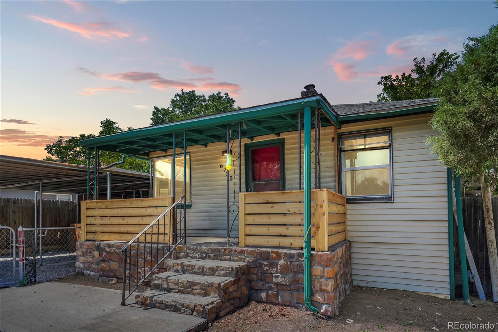 a view of a house with backyard and seating area