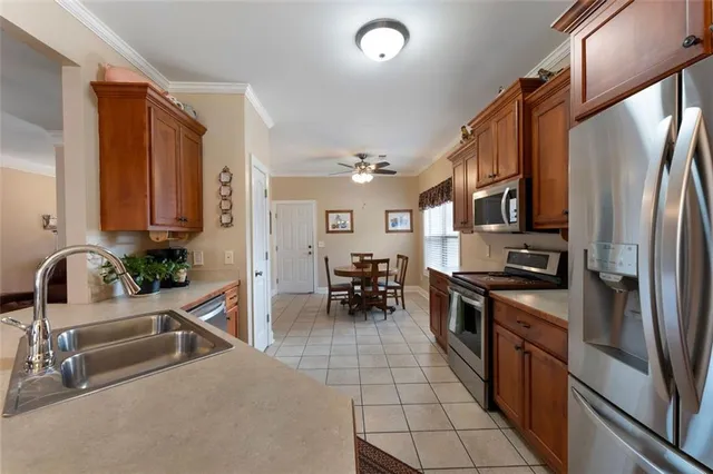 a kitchen with stainless steel appliances a sink a stove and a refrigerator
