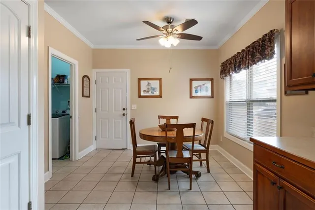 a view of a dining room with furniture and window