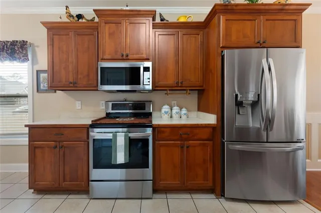 a kitchen with a refrigerator and a microwave