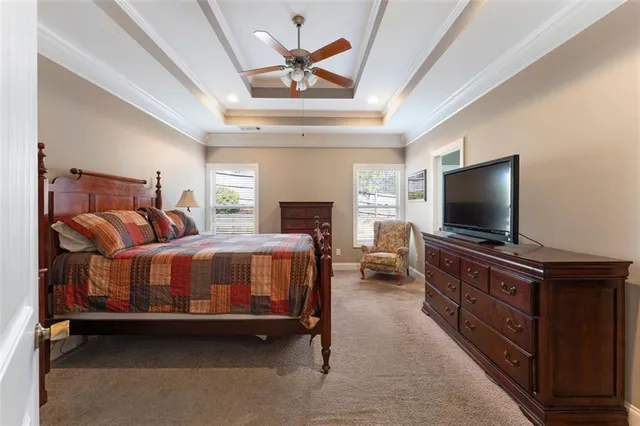 a bedroom with a bed and a flat screen tv on dresser