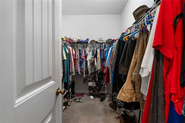 a view of walk in closet with clothes