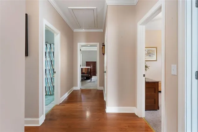 a view of a hallway with wooden floor and a living room